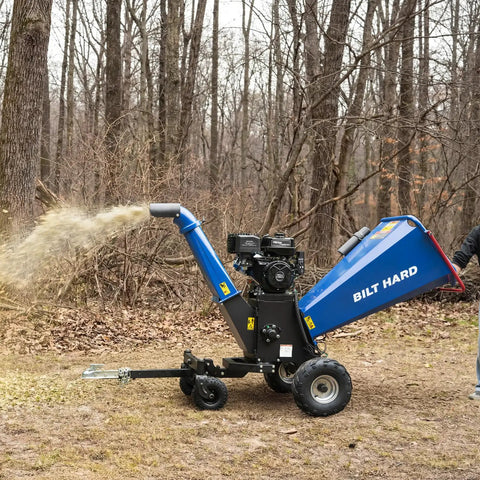 Towable 6 Inch Wood Chipper With Electric Start 15HP 420cc Gas Powered Engine in forest, chipping wood debris
