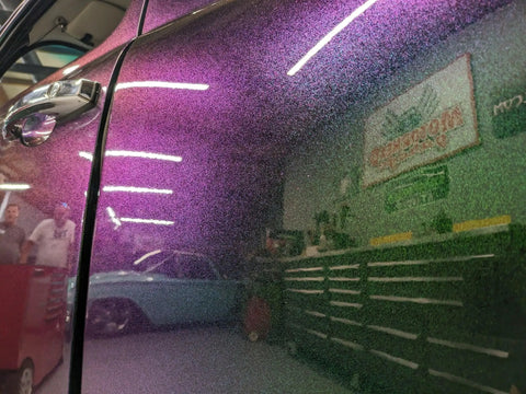 Close-up of Fresh Shop Grade Superflake Colorshift Basecoat Paint Gallon showing purple and green hues on vehicle door.