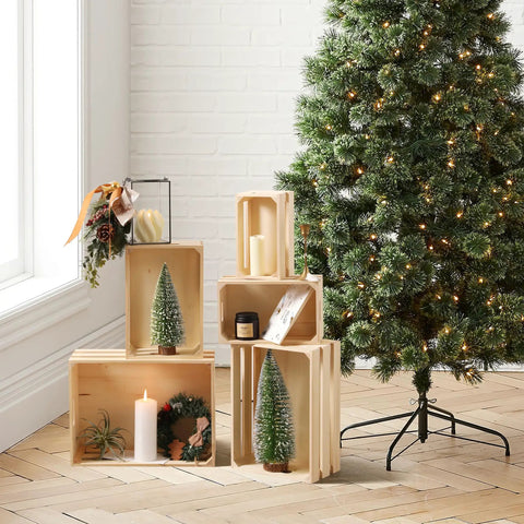 Vintage Rustic Wood Crates Set Of Five Nesting Storage Boxes With Open Handles displayed beside a decorated Christmas tree