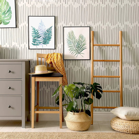 DIY Friendly Ink Lines Geometric Wall Stencil Set 2 Pack 17x39 Inches For Easy Accent Walls in a room with plants and framed prints.