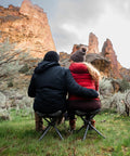 Couple sitting outdoors on Apex Fold-Up Stool G-140 Black Grey Ultra Portable Camp Seat for camping, hiking, sturdy support