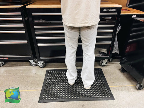Person standing on Anti Fatigue Rubber Floor Mat With Drainage Holes For High Traffic Areas Grippy Non Slip Doormat in garage