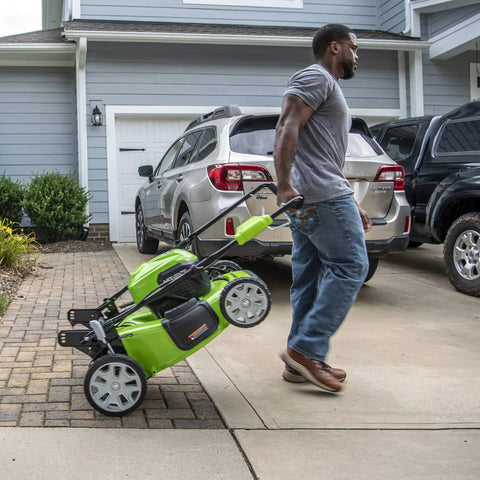 40V Cordless 21-Inch Brushless Push Mower With Dual 4.0Ah And 2.0Ah USB Batteries, Charger Included, Automatic Battery Switch-Over For Longer Run Time, Easy One-Lever 7-Position Height Adjustment, green mower in driveway