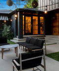 Ambience Pro Solar Powered Outdoor String Lights With Remote Control And Edison Bulbs hanging over a modern patio setup