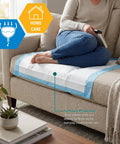 Top Shelf Super Absorbent Disposable Underpads 17 X 24 Inches Bone Dry Finish 100 Count Leak Proof Chux Pads on a couch.