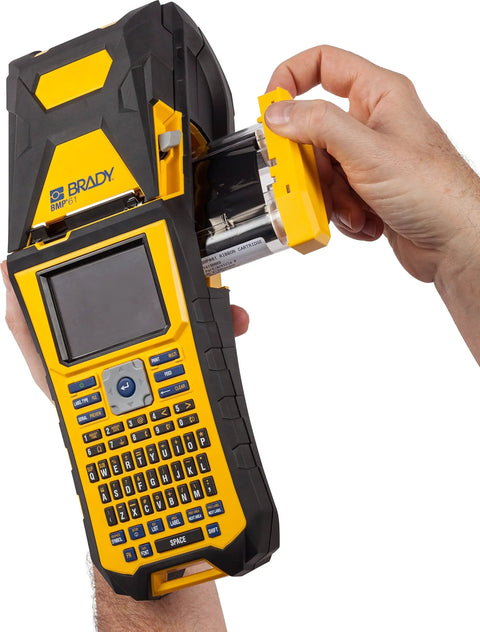 Built Tough Portable Handheld Label Maker With Rechargeable Battery For Multi Line Wire Tagging And Panel Identification Includes Hard Shell Case Usb Charger And Pre Loaded Ribbon being loaded with a ribbon cartridge.