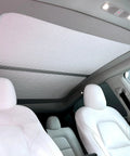 Fully Retractable Aluminum Sunroof Sunshade For Tesla Model Y Heavy Duty Heat Blocker And Natural Light Diffuser interior view with white seats.