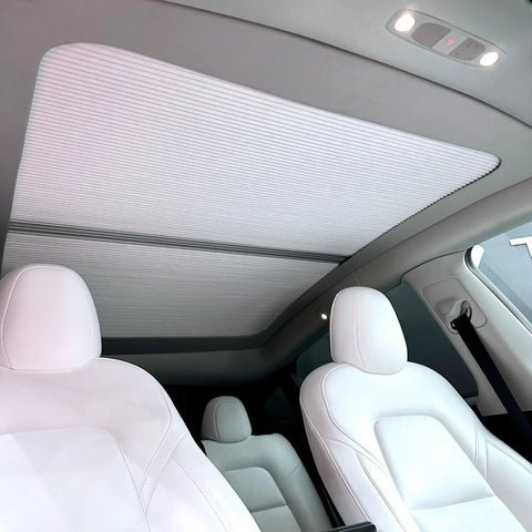 Fully Retractable Aluminum Sunroof Sunshade For Tesla Model Y Heavy Duty Heat Blocker And Natural Light Diffuser interior view with white seats.
