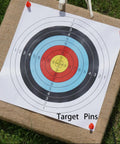 16 Pack Archery Target Pins for Holding Target Faces and Paper on EVA Foam Targets, shown securing target face outdoors