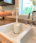Heavy Duty Toilet Plunger Kit With Smart Air Relief Valve And Spacious Tall Bucket Caddy in use above kitchen sink.