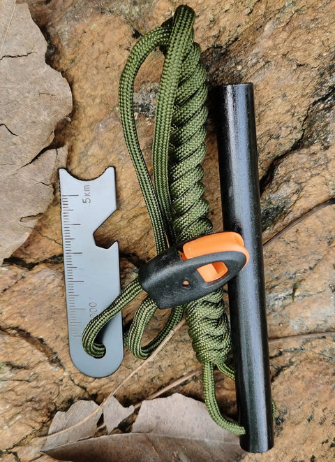 5 Inch Weatherproof Flint Ferro Rod Fire Starter Kit With Whistle And Paracord Lanyard Handle, Steel Multitool Striker on rock