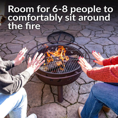 People warming hands at Bronze 30 Inch Outdoor Wood Burning Fire Pit With Grill Grate, Spark Screen, And Poker For Cozy Backyards And Campouts.