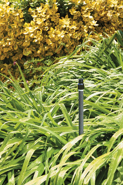 No Fuss Shrub Head Sprinkler With Quarter Pattern Spray Nozzle For Outdoor Gardens And Landscaping Rock Solid Durable Irrigation System seen in lush green grass.