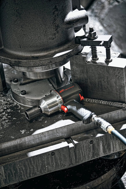Heavy Duty Half Inch Drive Pneumatic Air Impact Wrench Delivers Over 1100 Ft Lbs Of Bone Crushing Torque on workshop table