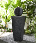 Outdoor LED Light Water Fountain With Submersible Pump Black Pedestal Modern Sphere Floor Fountain For Patio And Garden Decor Pebble Base Weatherproof Polyresin Construction 40 Inch High Yard Vibe, shown in a garden setting.
