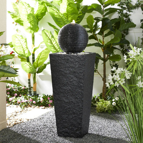 Outdoor LED Light Water Fountain With Submersible Pump Black Pedestal Modern Sphere Floor Fountain For Patio And Garden Decor Pebble Base Weatherproof Polyresin Construction 40 Inch High Yard Vibe, shown in a garden setting.