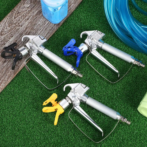 Heavy Duty Airless Paint Spray Gun 3 Pack With 513 515 519 Tips on grass, featuring stainless steel construction and ergonomic grips.