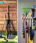Mop And Broom Holder Wall Mount With Five Slots And Six Hooks installed, showing organized tools in home garage.