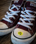 Red Converse sneakers with Yard Sale EZ Kit Neon Yellow Signs 11 By 14 Inches With 600 Prepriced Stickers $5 label on toe.