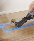 Dremel 575 right-angle attachment on a rotary tool grinding a wooden surface.