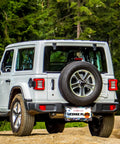 Jeep with an Abalone Shell License Plate Frame Made From Stainless Steel For Front And Rear Car Tags With Screws Durable 6.3 By 12.2 Inches Adds Unique Style To Your Ride For Women And Men A Fun Car Decoration Accessory, parked in a forest setting
