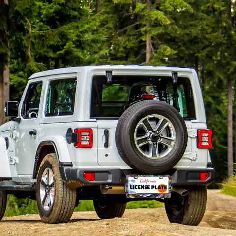 Jeep with an Abalone Shell License Plate Frame Made From Stainless Steel For Front And Rear Car Tags With Screws Durable 6.3 By 12.2 Inches Adds Unique Style To Your Ride For Women And Men A Fun Car Decoration Accessory, parked in a forest setting