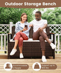 Two people seated on Wicker Outdoor Storage Bench With Hidden 46 Gallon Gas Strut Lift Up Storage, rattan design.