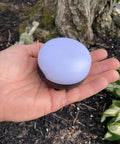 Hand holding Moji Lantern 100 Lumen Camp Light With Diffused LED Output, Compact One Button Operation, AAA Powered, graphite finish