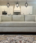 Adjustable Under Couch Gap Shield Blocking Toys Dust And Remotes From Snaking Under Sofas with flexible core, shown in modern living room.