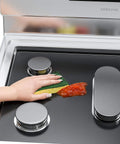 Cleaning Reusable Gas Range Protectors For 5 Burner Stove With Nonstick Surface on Samsung gas burner with sponge and sauce.