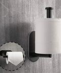 Matte black stainless steel toilet paper holder with adhesive mount, vertical installation, shown holding a roll, modern bathroom accessory.