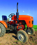 An orange tractor on a green field with blue sky background.