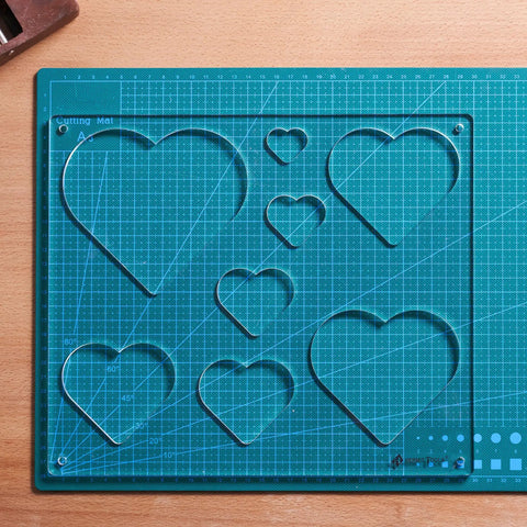 12 By 10 Inch Heart Inlay Router Template Guide Kit For Woodworkers Straight Up Perfect Decorative Doughnut Jigs Making Eight Sizes No Sweat Routing Every Time displayed on a cutting mat.