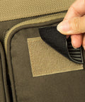 Close-up of US flag patch being applied on Heavy Duty Tactical Range Duffel With MOLLE Gear, Lockable Zippers, Khaki 27 Inch