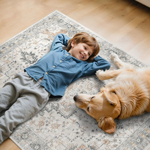 Child and dog lying on a decorative rug on a hardwood floor.