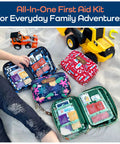 Overhead view of four KeepGoing Kids Travel First Aid Kits (130 pc) in colorful zip pouches with clear pockets on sand.