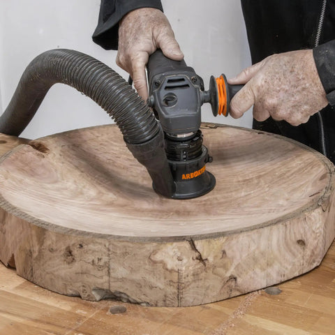 Heavy Duty Power Carving Tool Attachment Featuring A Slick Two Inch Cutting Disc And Adjustable Sanding System used on raw timber.