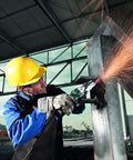 Worker using 6 Inch Flat Head Angle Grinder With Non Locking Paddle Switch And Brake, 13.5 Amp, cutting metal sheet, sparks flying