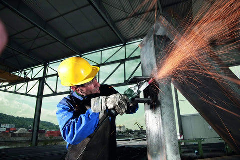 Worker using 6 Inch Flat Head Angle Grinder With Non Locking Paddle Switch And Brake, 13.5 Amp, cutting metal sheet, sparks flying