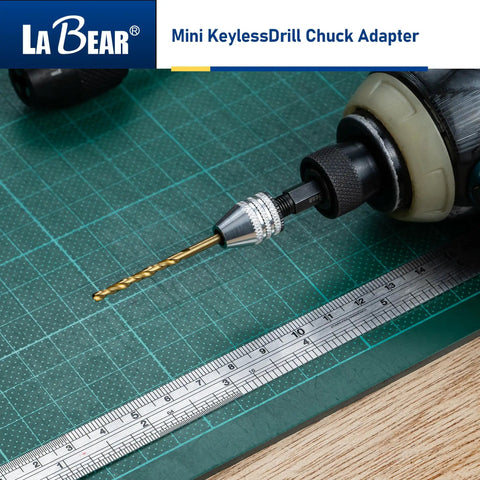 Keyless Mini Drill Chuck Adapter With One Quarter Inch Hex Shank And Quick Swap Rig for cordless drivers held over a cutting mat.