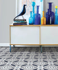 Grey Peel And Stick Floor Tiles Pack Of 10 Geometric Vinyl Flooring Water Resistant 12 In By 12 In Easy Diy Install No Grout Needed Durable Adhesive Low Lustre Finish beneath modern cabinet and colorful vases, showing Suzani pattern in living room setting.