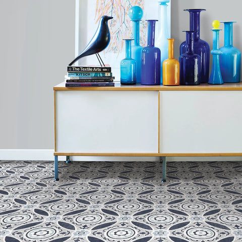 Grey Peel And Stick Floor Tiles Pack Of 10 Geometric Vinyl Flooring Water Resistant 12 In By 12 In Easy Diy Install No Grout Needed Durable Adhesive Low Lustre Finish beneath modern cabinet and colorful vases, showing Suzani pattern in living room setting.
