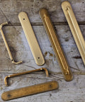 2 Pack Champagne Bronze Cabinet Pulls With Backplates, 7 1/2 Inch Center-to-Center Drawer Handles on rustic wood surface