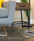 Three Outlet Extension Cord With 25 Foot Grounded Power Cord For Home Office And Media Setups coiled on floor near sofa and table