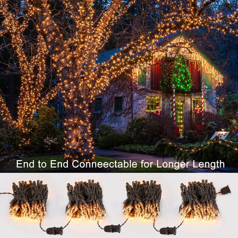 Clear Christmas Lights String With Brown Wire 21 Feet Long 100 Incandescent Bulbs decorating house and tree at night