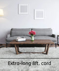 Living room scene with extra-long 8 ft. cord of Surge Protector Power Strip With Six Outlets Eight Foot Extension Cord 1300 Joules Of Surge Protection Flat Plug Twist To Close Safety Covers ETL Listed Black Perfect For Home Office And Gear.