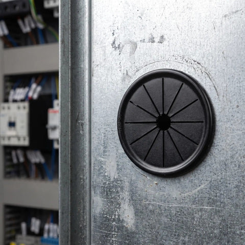 Check These 10 Pack Black Cable Grommets For Your Desk. Petalshaped Design Makes Wiring A Breeze With Secure Grip Locking Tabs To Save The Day And Keep Cords Safe From Damage While Styling Out Your Setup. black nylon cable grommet on metal desk panel, front view