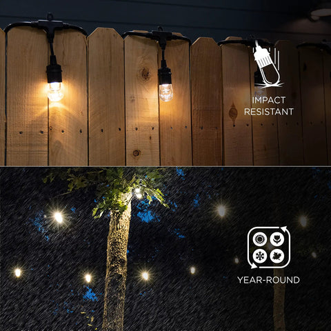 Cozy Cafe Style Outdoor String Lights With 48 Ft Black Cord 24 Shatterproof Acrylic Edison Bulbs Weatherproof For Patio Deck Garden Bars And Cafes Warm White Ambience For Indoor Or Outdoor Parties illuminating wooden fence and trees.