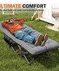 Man relaxing on Camping Cot With Cushioned Comfort For Adults on grass, showing portability and comfort features.