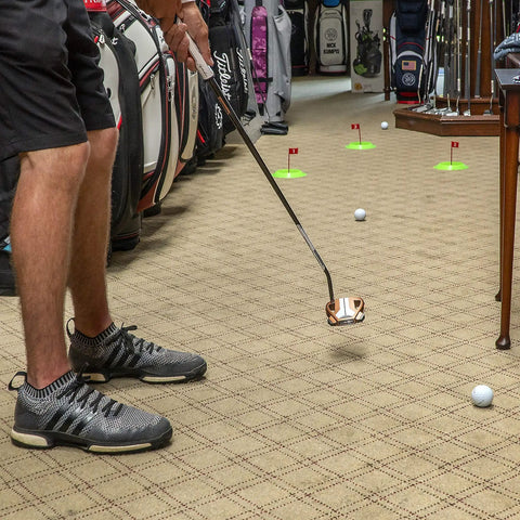 Man practicing indoors with Pure Putt Challenge Three Pack Putting Cups For Indoor And Outdoor Practice Anywhere, USGA-size holes